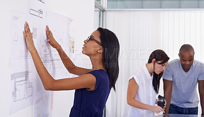 Buy stock photo Woman, architect and planning with board of documents or paperwork in meeting for architectural design at office. Female person, contractor or designer with team for floor plan or ideas at workplace