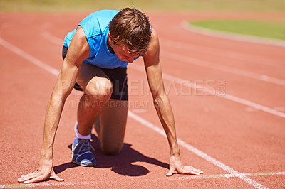 Buy stock photo Man, athlete and start run on race track for sports, fitness and focus for speed and action outdoor. Exercise, workout and training at stadium or arena, cardio and health with fast runner or sprinter