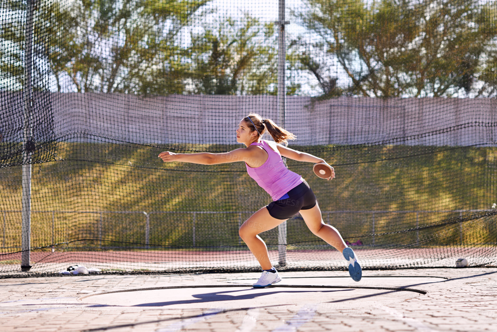 Buy stock photo Shot of a young athlete practicing the discus