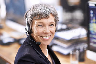 Buy stock photo Shot of an mature female call center representative wearing a headset