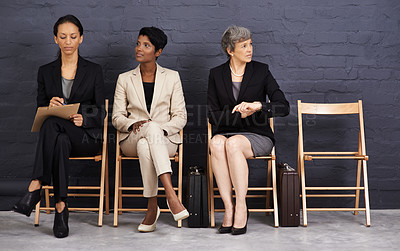 Buy stock photo A shot of a group of businesswomen sitting on chairs