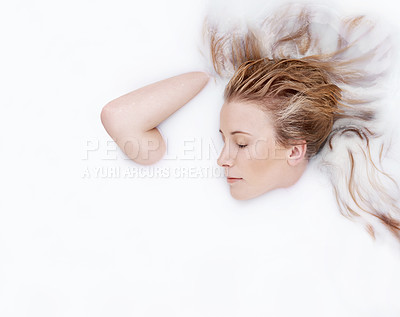 Buy stock photo Shot of an attractive woman largely submerged in milky liquid