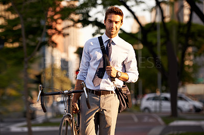 Buy stock photo Bicycle, city and portrait of businessman in morning for travel, commute and walking to work. Professional, urban town and happy person with bike for cycling, sustainable and eco friendly transport