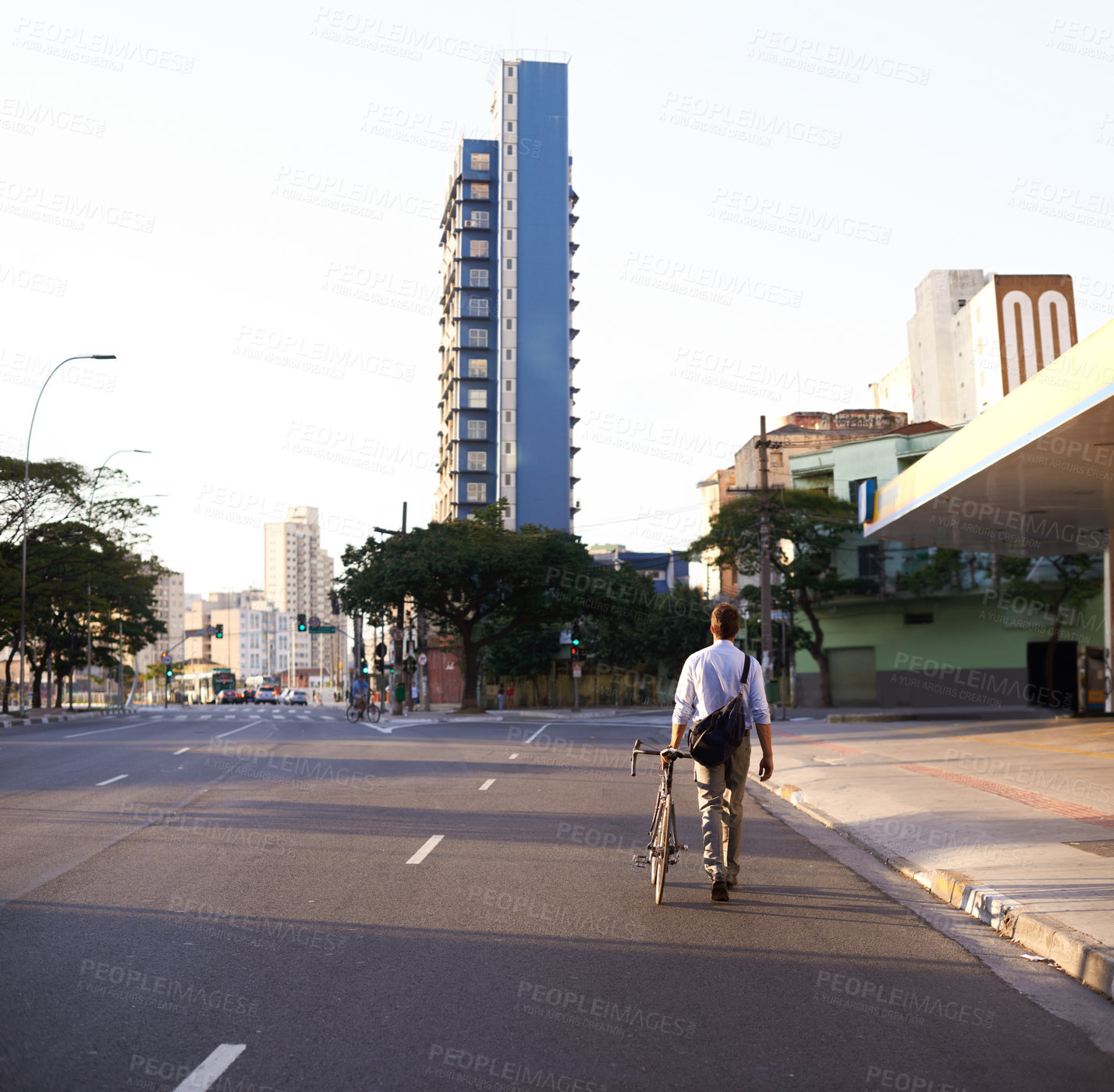 Buy stock photo Bicycle, city and business man in street for travel, morning commute and walking to work. Professional, urban town and back of person with bike for cycling, sustainable and eco friendly transport