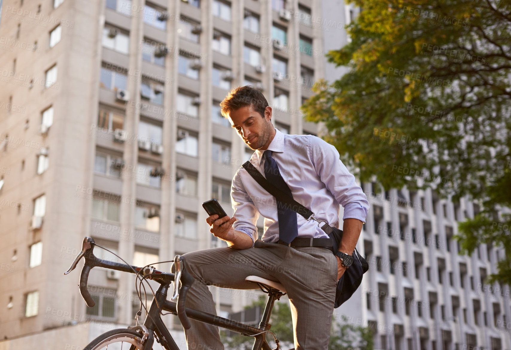 Buy stock photo Bicycle, businessman and smartphone for sustainable travel, transportation and communication in city. Cellphone, commute and male employee on bike for cycling, carbon neutral or texting in urban town