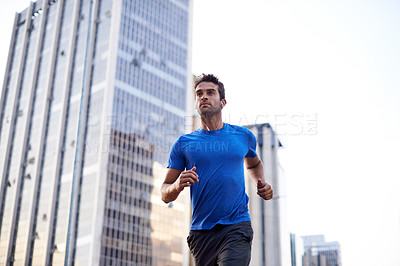 Buy stock photo Fitness, workout and man running in the city for health, wellness or training for a marathon. Sports, runner and male athlete doing an outdoor cardio exercise for endurance or speed in an urban town.