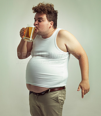Buy stock photo Chubby, weight gain and beer for man in studio with alcohol for unhealthy habit, plus size and humor. Overweight person with glass in hand and drinking with fat stomach for comedy, joke and funny