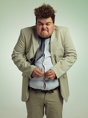 Buy stock photo Plus size, man and fitting in shirt for abdomen, professional and annoyed with clothes for work. Adult, male person and guy with stomach, unhappy and upset with of belly in suit for job in studio