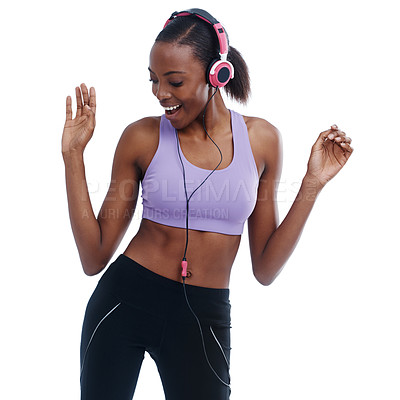 Buy stock photo A woman in sportswear happily listening to music with her headphones