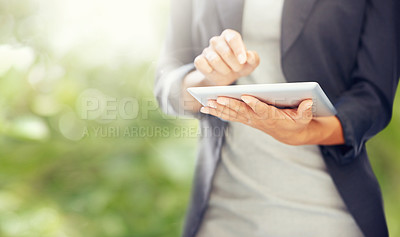 Buy stock photo A cropped image of a businesswoman working on a digital tablet