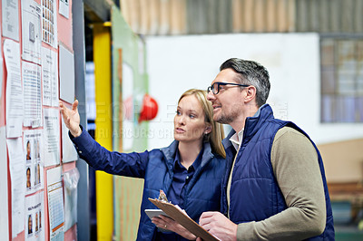 Buy stock photo Cropped shot of a two coworkers managing a warehouse