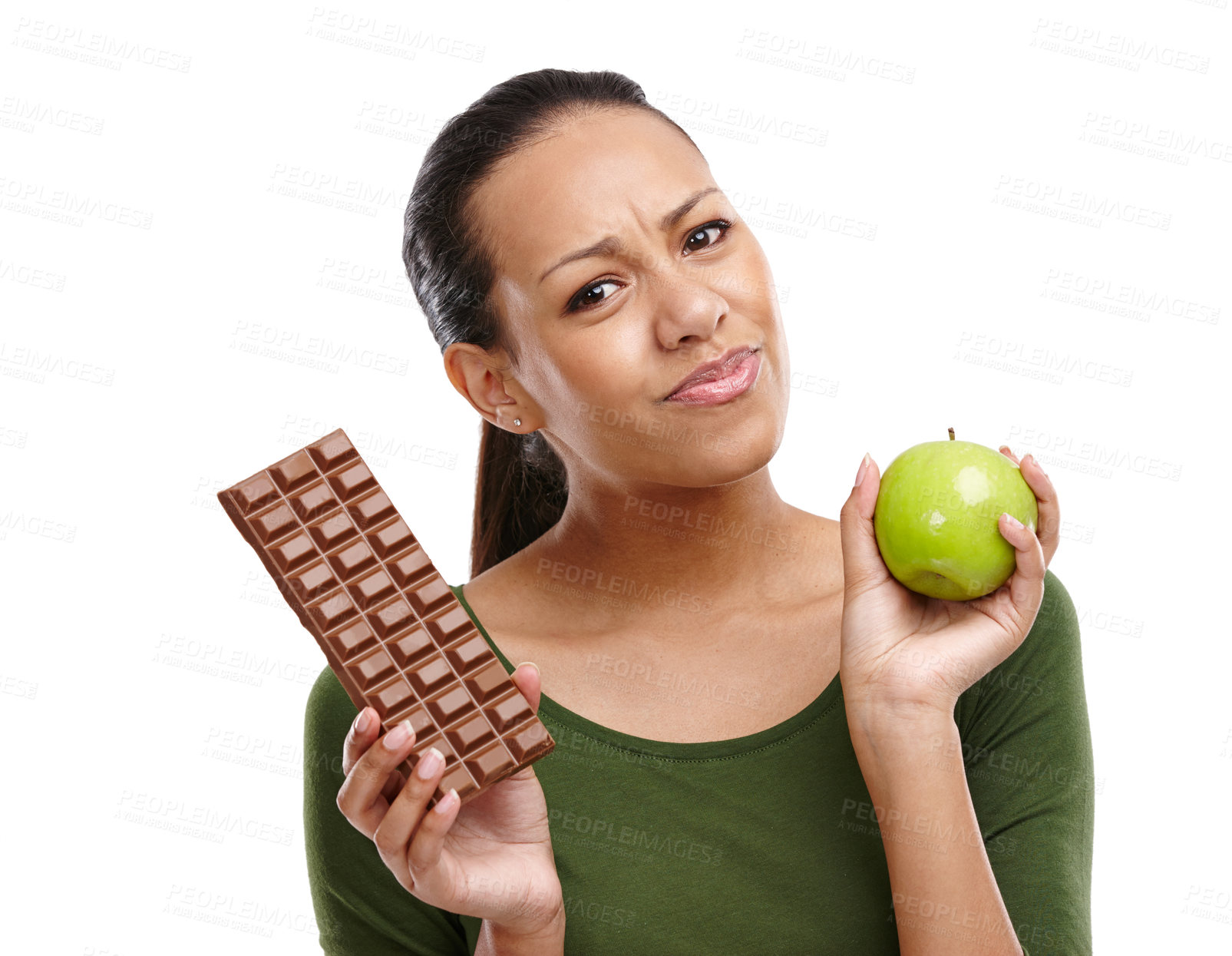 Buy stock photo Portrait of a young woman trying to decide between chocolate and an apple isolated on white