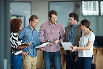 Buy stock photo Talking, planning or meeting group of colleagues brainstorming ideas, discussing strategy on paperwork and collaboating. Business man explaining reports to a diverse creative marketing team in office