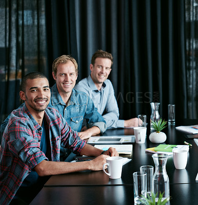 Buy stock photo Portrait of a diverse group of professionals sitting at a table in a boardroom