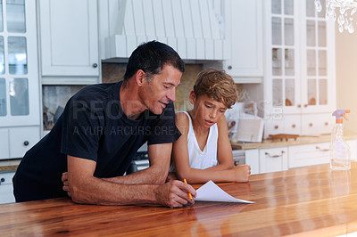 Buy stock photo Cropped shot of a father going over a list of chores with his son at home