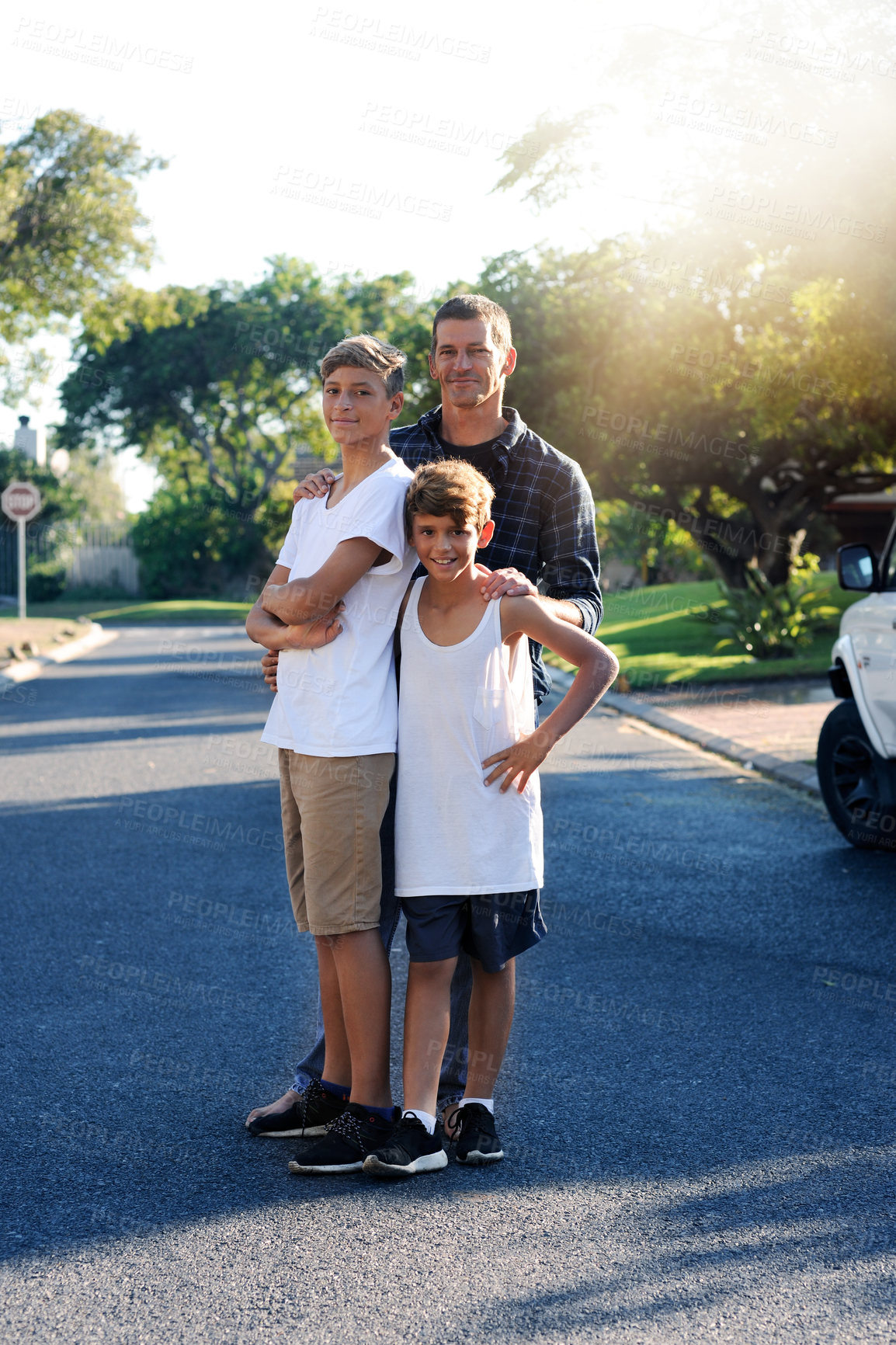Buy stock photo Portrait of a father standing with his two young sons outside