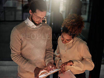 Buy stock photo Man, tablet and office in night with black woman, discussion or web design with check, decision or strategy. Teamwork, it goals and ux designer group for ideas, vision and dark workplace for analysis