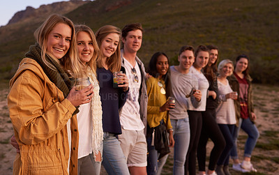 Buy stock photo Portrait of a group of friends admiring the landscape while enjoying a drink together outside