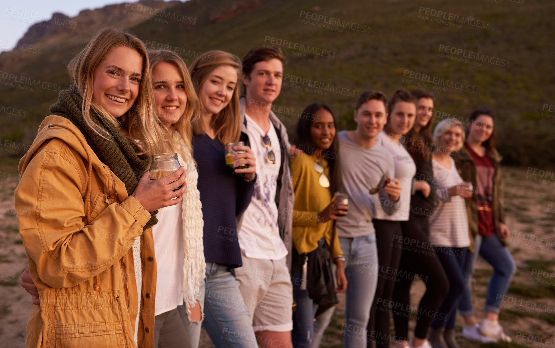 Buy stock photo Portrait of a group of friends admiring the landscape while enjoying a drink together outside