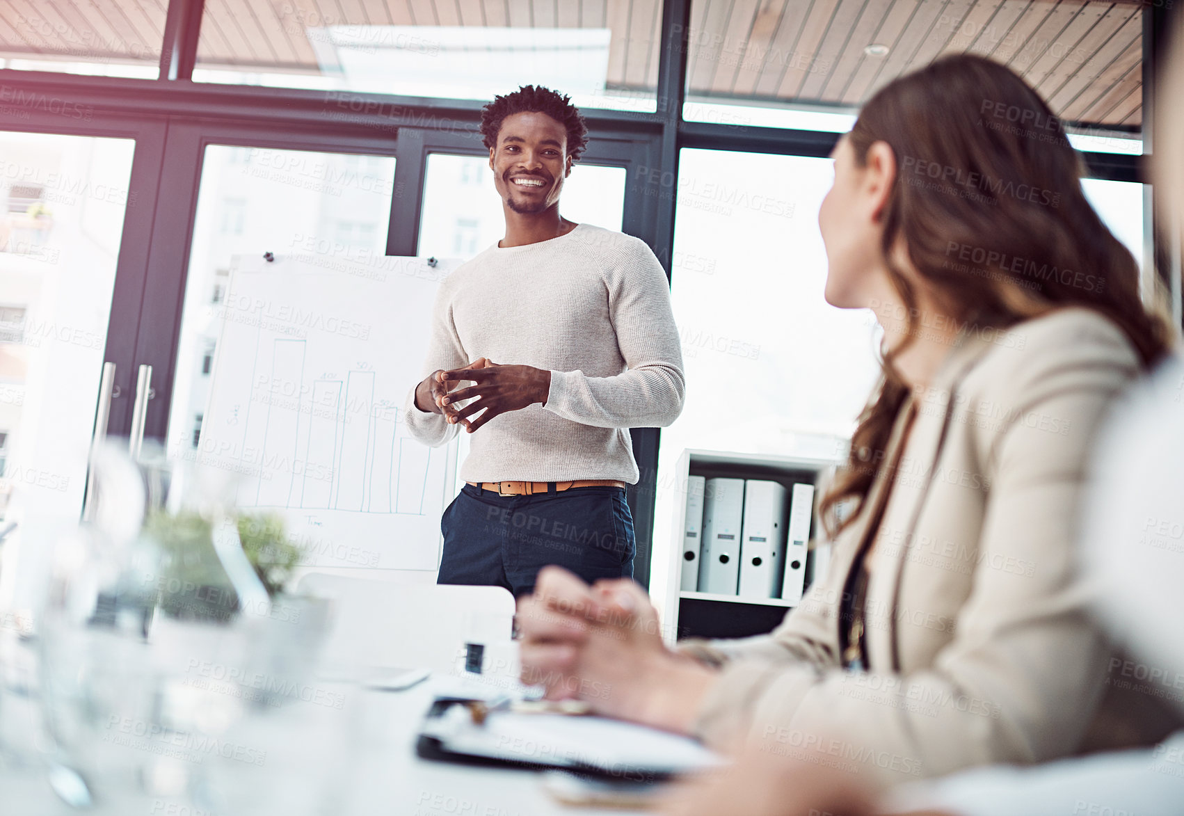 Buy stock photo African man, white board and talking with coworkers for presentation and career project ideas in meeting. Professional male analyst and happy with bar graph for research data, statistics and planning