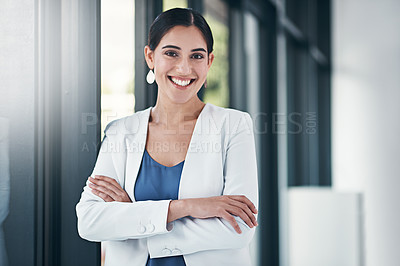 Buy stock photo Portrait of a successful businesswoman standing with her arms folded in the office