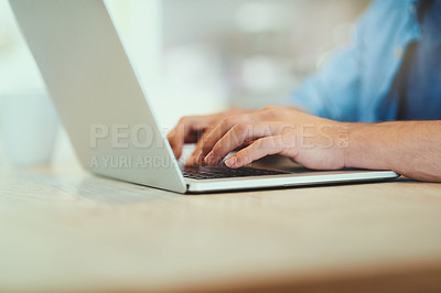Buy stock photo Shot of an unrecognizable man using his laptop at home