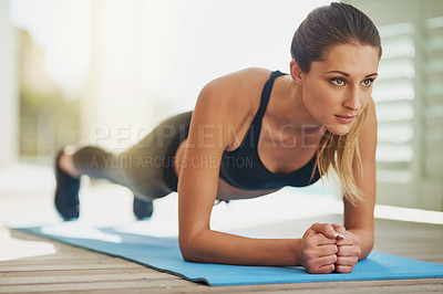 Buy stock photo Shot of an attractive young woman planking on her patio