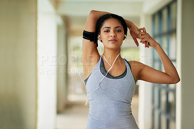 Buy stock photo Portrait of a sporty young woman warming up before a run