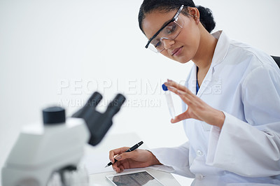 Buy stock photo Cropped shot of an attractive young female scientist working in her lab