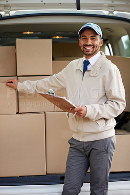 Buy stock photo Portrait of a friendly delivery man standing next to a van full of boxes