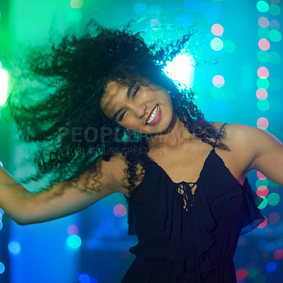 Buy stock photo Shot of a beautiful young woman dancing in a nightclub
