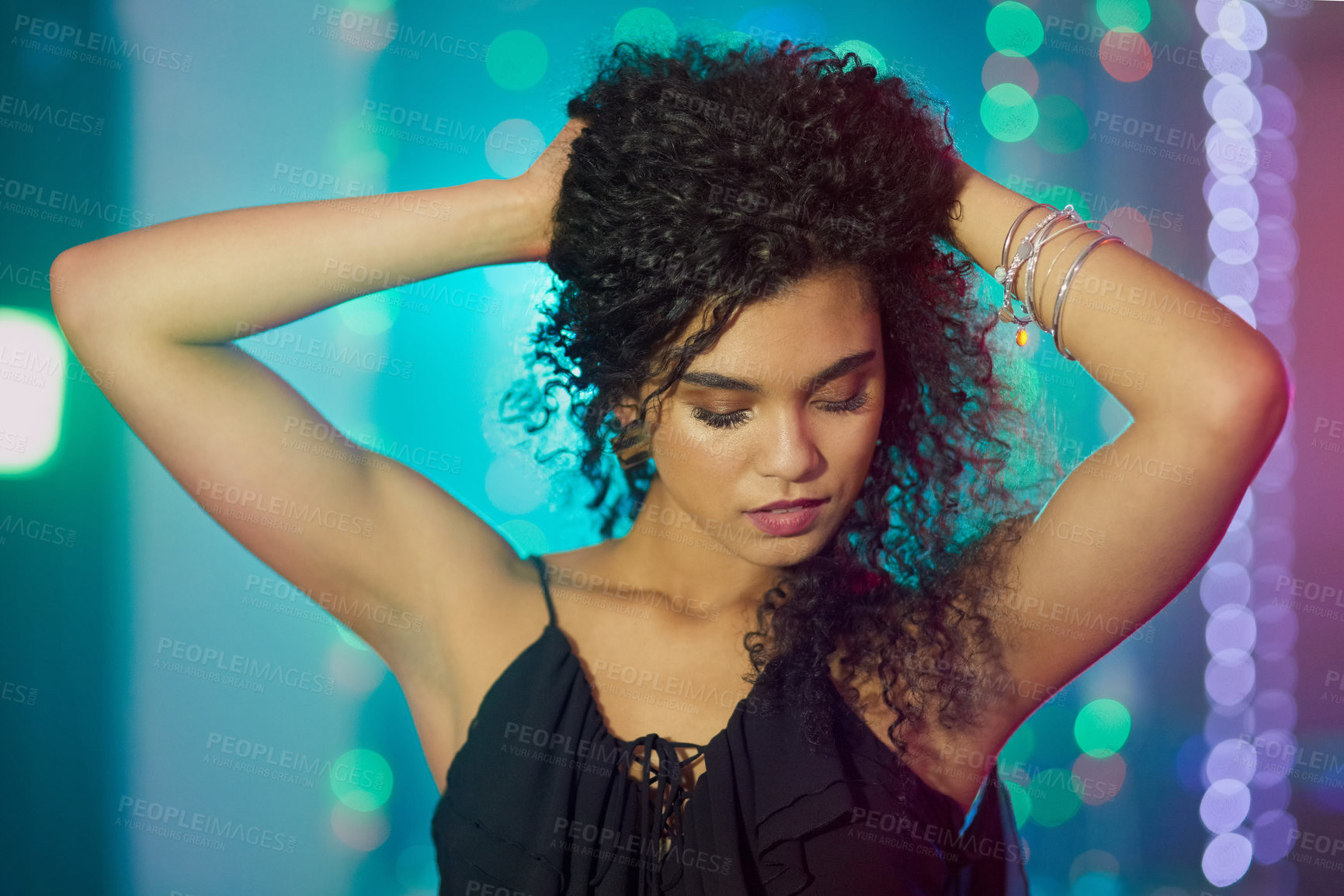 Buy stock photo Dancing, fun and black woman in club, night and party in weekend, break and hand on hair and pride. Bokeh, lights and person in concert, energy and rave to relax, celebration and music in disco