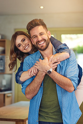 Buy stock photo Portrait of a happy young couple embracing at home