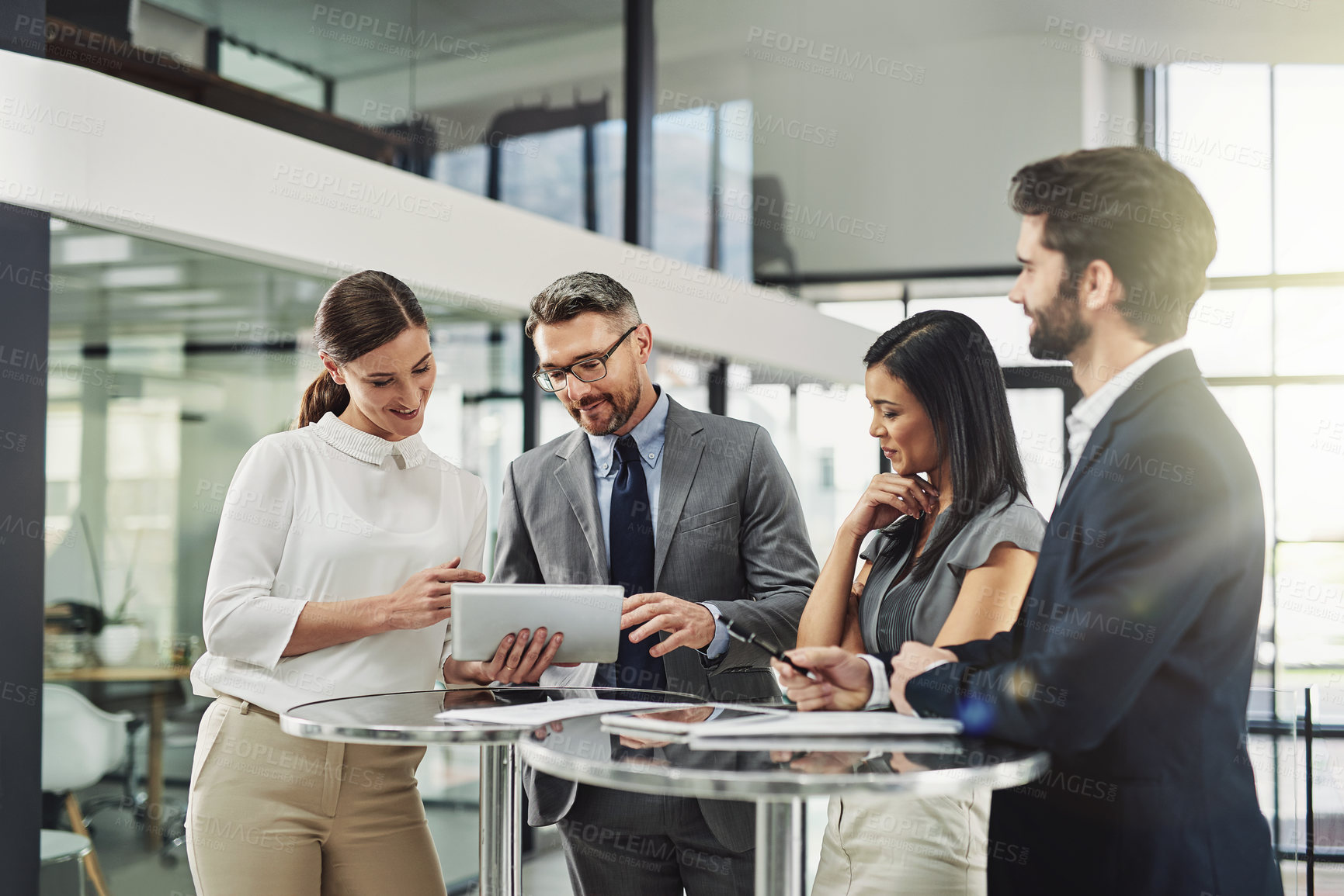 Buy stock photo Shot of a group of colleagues discussing business in the office