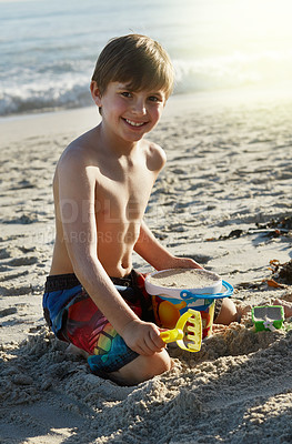Buy stock photo Portrait of a little boy playing in the sand at the beach