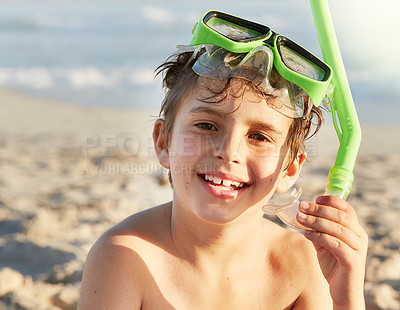 Buy stock photo Portrait of a little boy wearing a mask and snorkel at the beach
