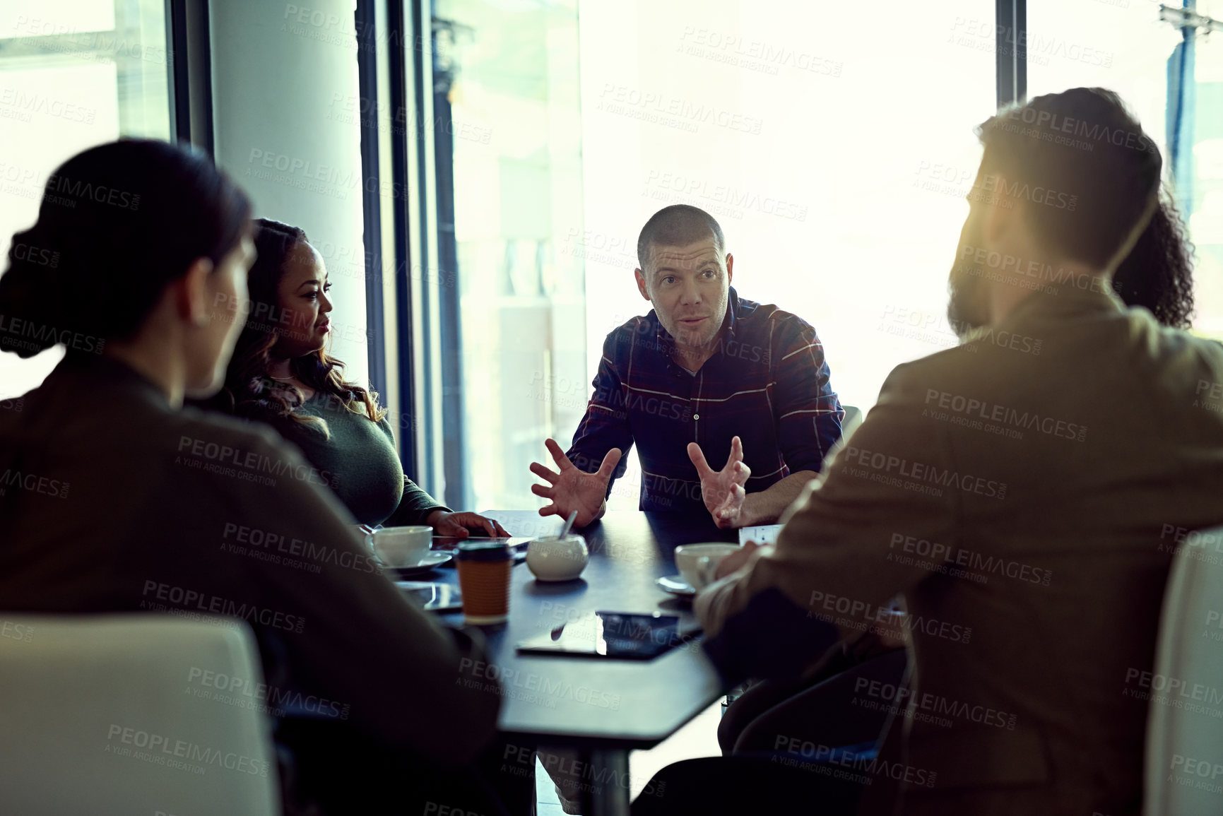 Buy stock photo Cropped shot of a group of businesspeople meeting in the boardroom