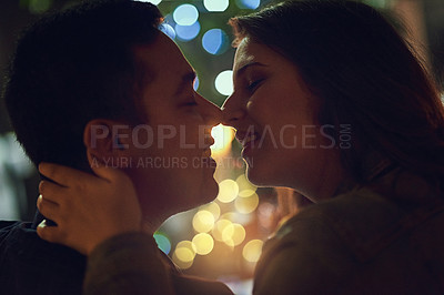 Buy stock photo Date, kiss and couple at restaurant for engagement, anniversary or celebration with love. Bokeh, marriage and romance with partner embrace for happy people at night with relationship in dark