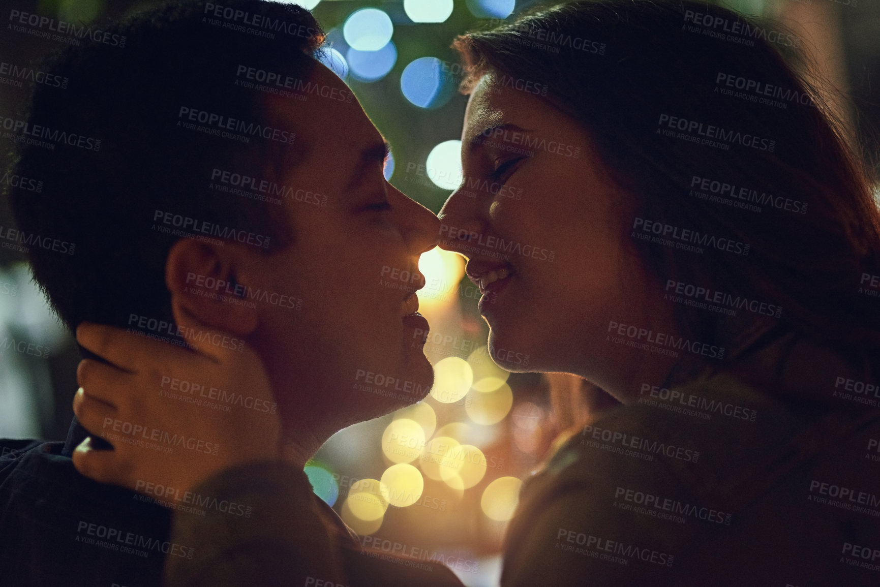 Buy stock photo Date, kiss and couple at restaurant for engagement, anniversary or celebration with love. Bokeh, marriage and romance with partner embrace for happy people at night with relationship in dark