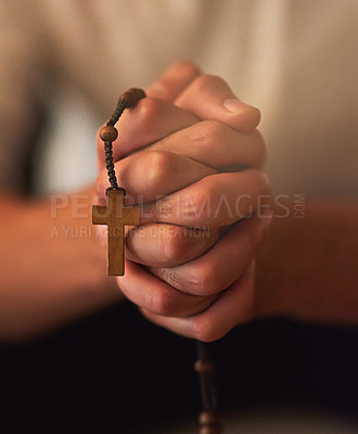 Buy stock photo Cropped shot of a man holding a rosary and praying