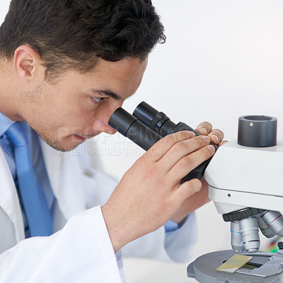 Buy stock photo Cropped shot of a young male scientist working in his lab