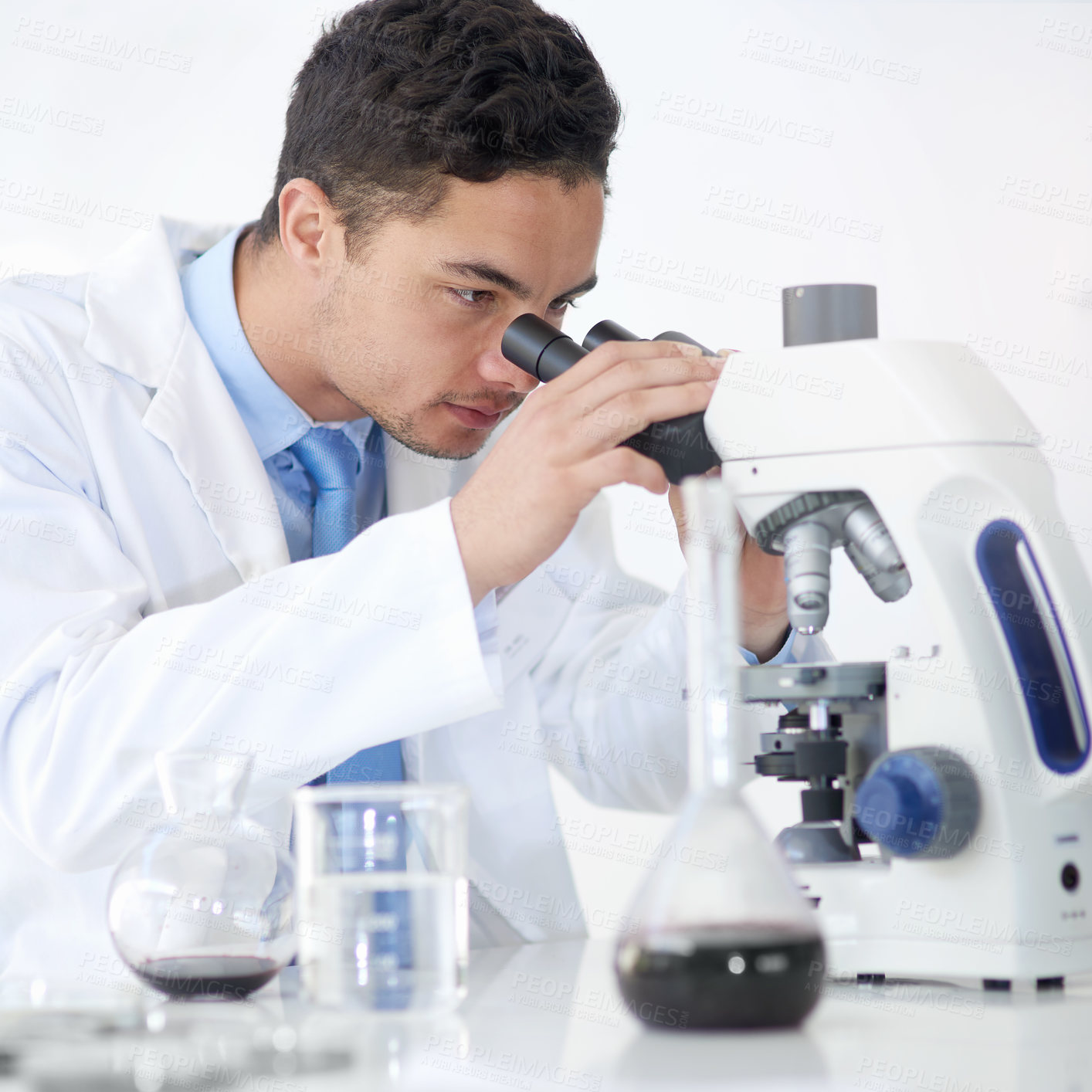 Buy stock photo Cropped shot of a young male scientist working in his lab