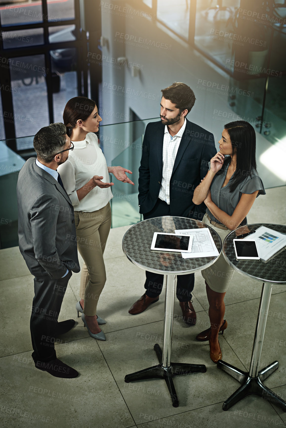 Buy stock photo High angle shot of a group of businesspeople meeting in the office