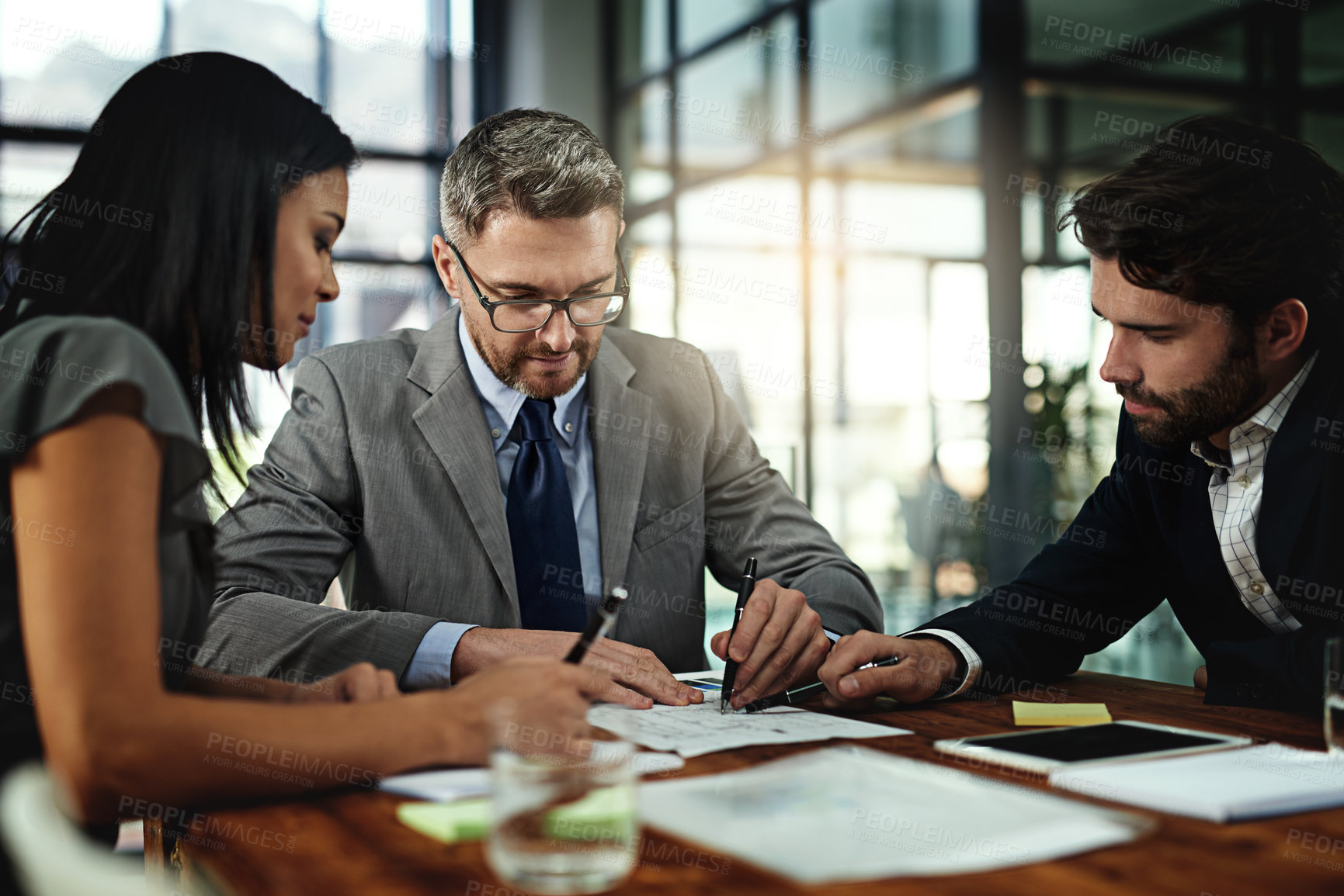 Buy stock photo Shot of a group of businesspeople meeting in the boardroom