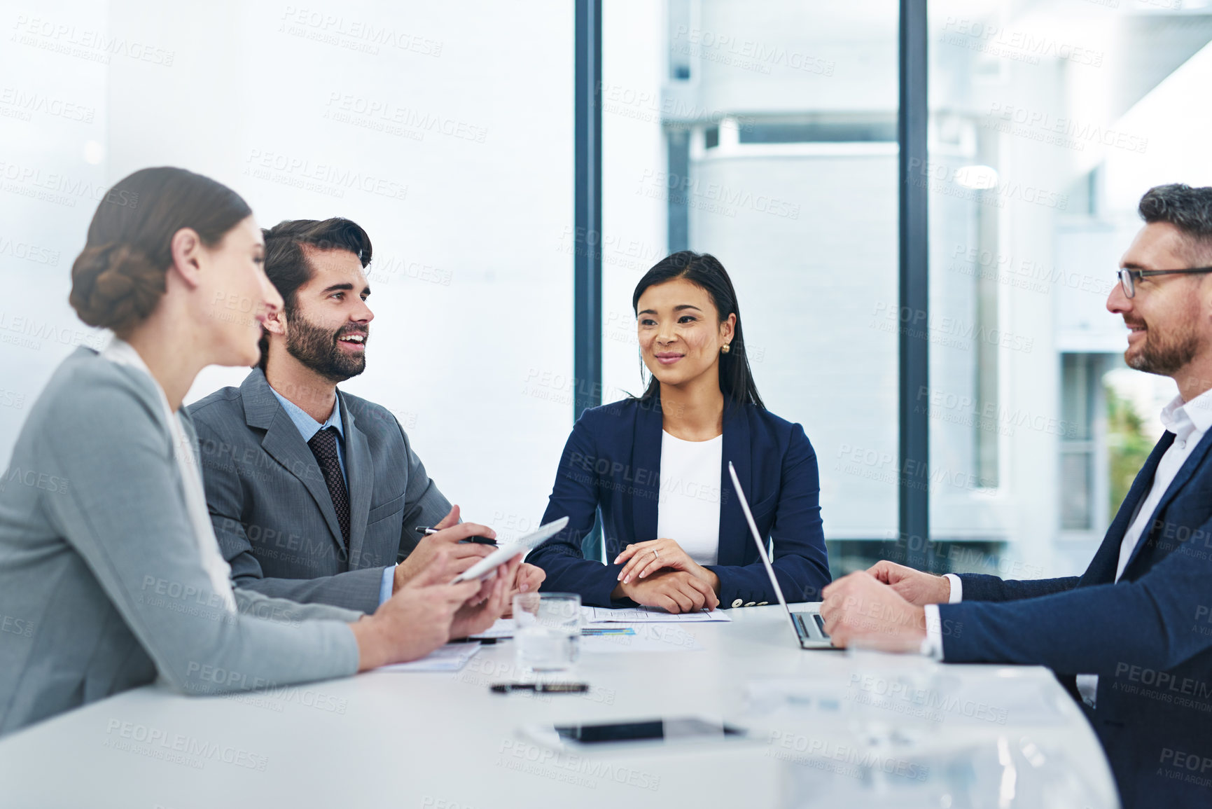 Buy stock photo Shot of a group of corporate businesspeople meeting in the boardroom