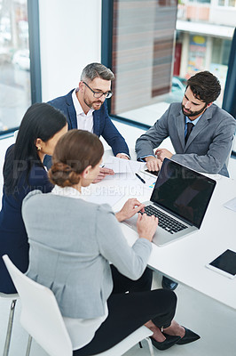 Buy stock photo High angle shot of a group of corporate businesspeople meeting in the boardroom