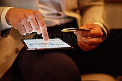 Buy stock photo Shot of an unrecognizable businessman using his tablet to shop online in the office