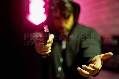 Buy stock photo Portrait of a gun-wielding thief aiming his weapon