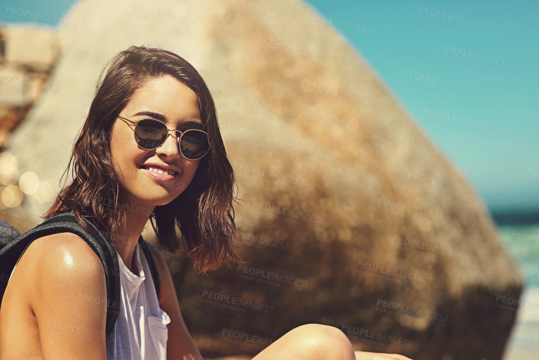 Buy stock photo Shot of an attractive young woman enjoying a day on the beach