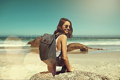 Buy stock photo Shot of a backpacker enjoying a day at the beach